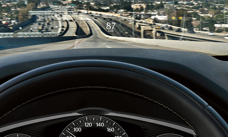 Driver’s view, 87 km/h is projected onto the CX-90's interior windshield.