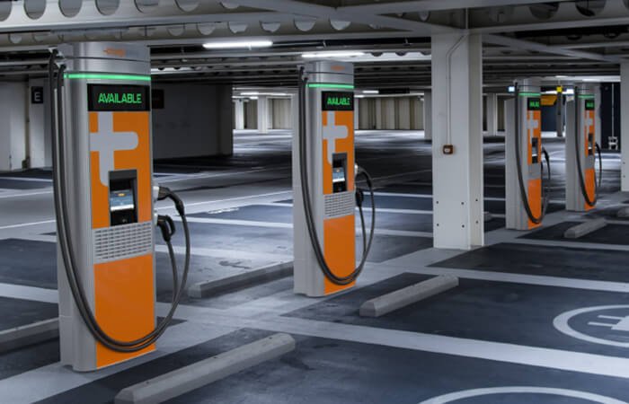 Two green and white public chargers side by side. 