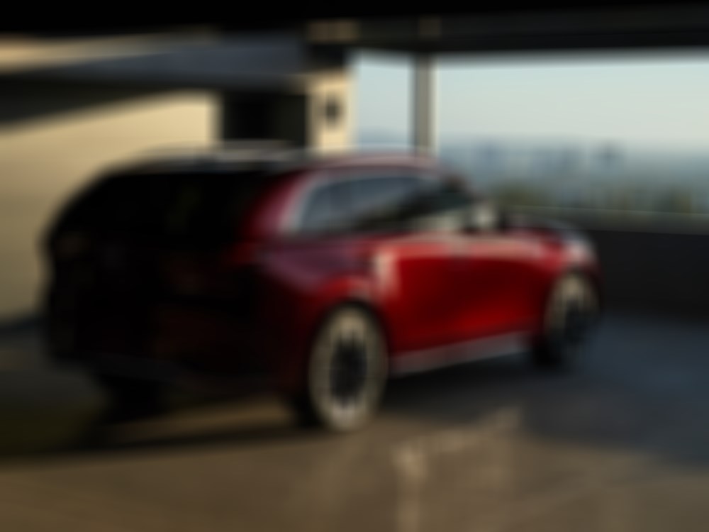 Artisan Red CX-90 in parking garage at sunset. 