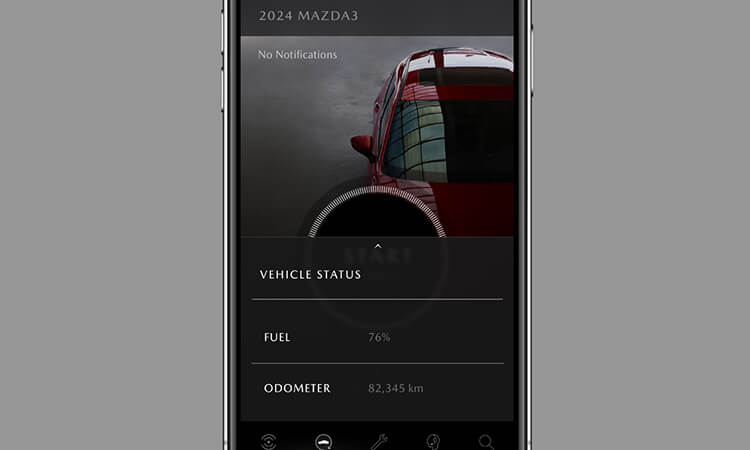 Smartphone with MyMazda app on Vehicle Status screen.